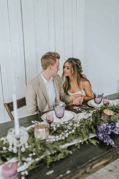 Lake Tahoe Elopement Photographer captures bride and groom sitting together at table