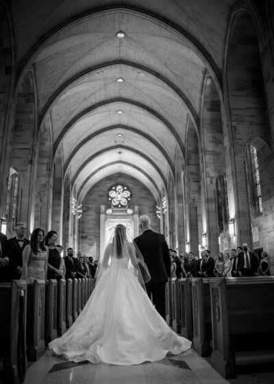 Indian couple walking up the steps of a museum to their reception