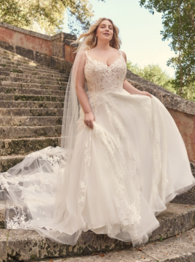 Boho Tulle A-line Wedding Dress. A portrait of a lady-a bride who knows what she likes, at the height of her style game, wearing a boho tulle A-line wedding gown inspired by big bouquets and summer celebrations.