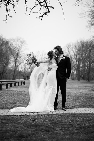 A newlywed couple poses for portraits during their wedding reception at The Woodlands at Algonkian, following their wedding ceremony at Potomac Baptist Church in Sterling, Virginia, captured by Nathan Sottung Photography.