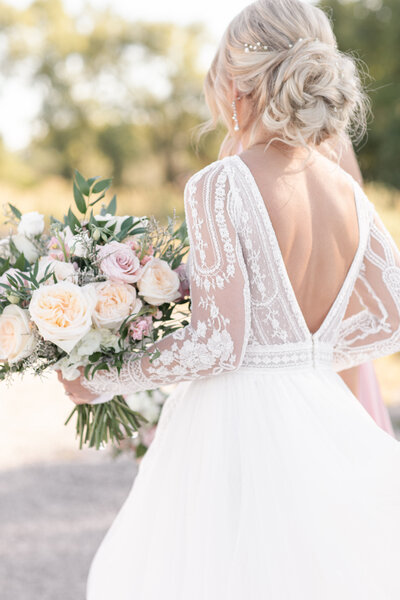 Photo of Bride holding bouquet by Courtney Rudicel, a wedding photographer in Fort Wayne