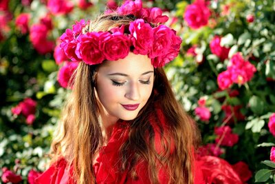 Young woman wearing a wreath of pink flowers in  celebration of the Beltane Sabbat