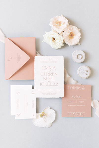 wedding flatlay with pink envelopes