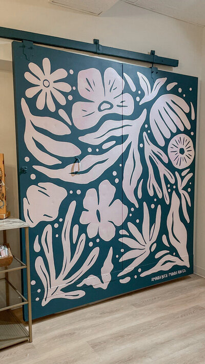 Abstract, floral mural design for door inside clothing and goods boutique by Wild Her & Co.