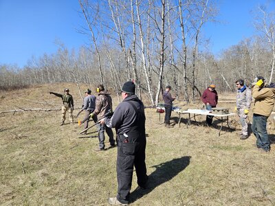 Leaders engaged in outdoor experiential learning activity focused on communication and trust