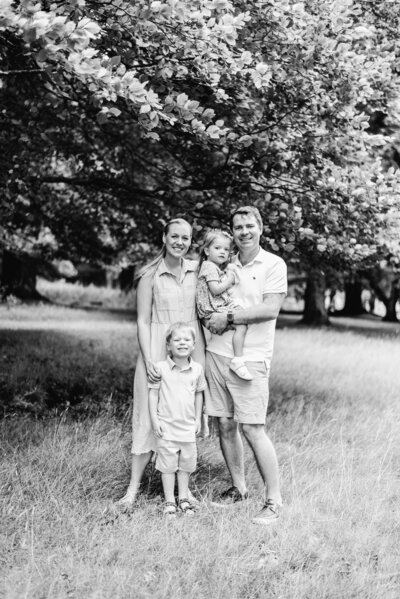 A family all standing next to each other at a family photography session in Billingshurst