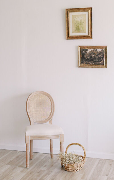 white chair and paintings in the walls