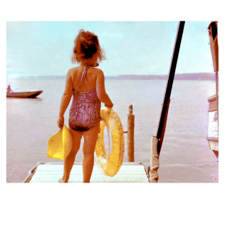 young girl playing on dock at lake