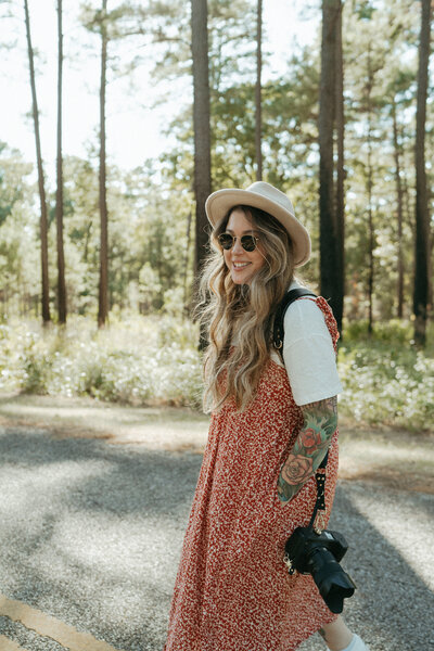 girl in a hat with blonde hair smiling