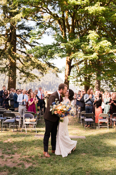 Bride and Groom kissing at Nature Bridge Lake Crescent