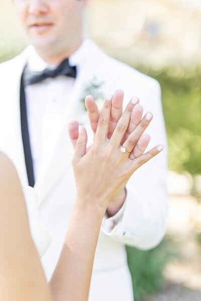 Couple holding hands in Malibu Lake wedding venue in California.