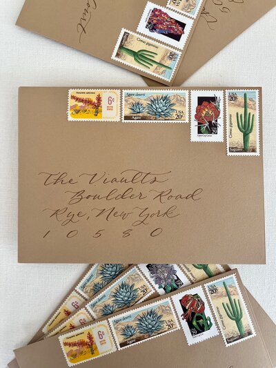 Kraft paper envelopes with calligraphy and Southwestern themed postage stamps