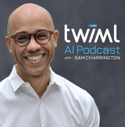 photo of a male in his 30s with no hair wearing glasses and a white button up shirt smiling at camera with twiml next to him this week in machine learning with same charrington