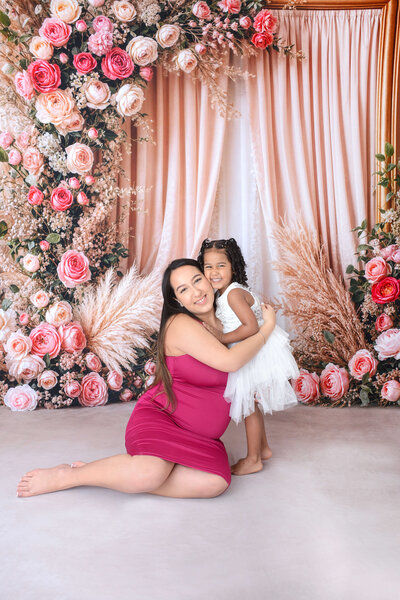 mom little sister and big brother smile at their photoshoot