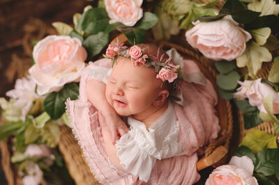 dark haired baby girl in beige frilly dress sleeping in outdoor session.