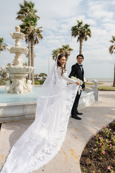 bride and groom in texas near water fountain captured by texas wedding photographer