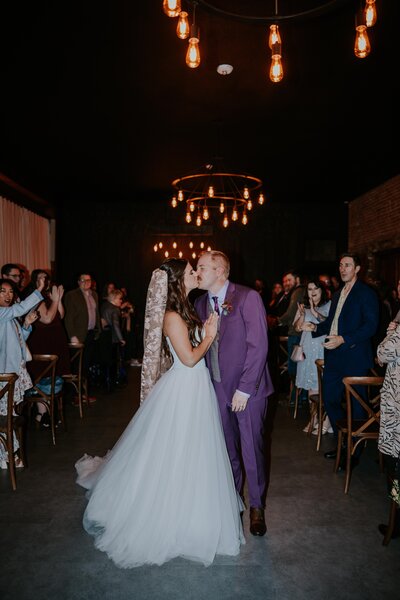 Destination wedding photographers captures couple kissing at their minnesota wedding ceremony