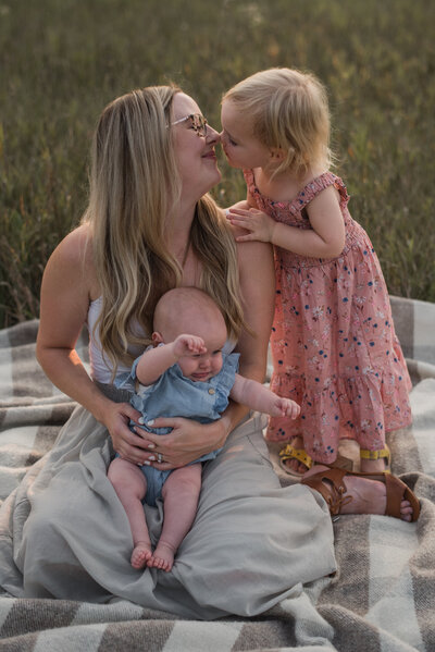 mother spinning in dress with baby in arm, moonlight in background