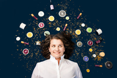 woman is surrounded by skin care products