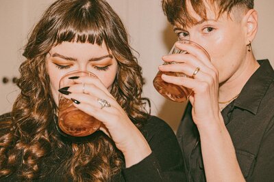 couple taking a drink at their idaho wedding