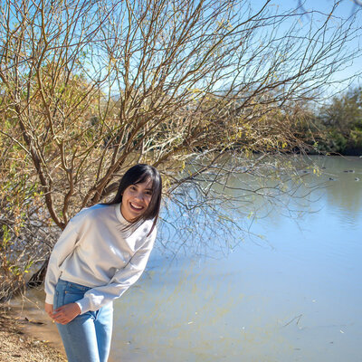 Laci smiles by the water in Riperian Park