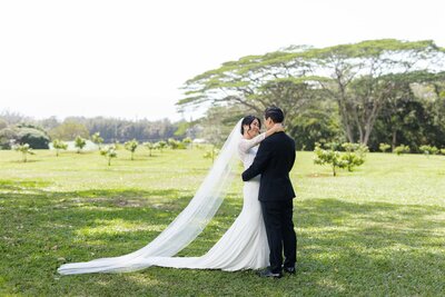 A newlywed couple dancing in a field 