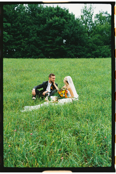 Charis and Gabe celebrate their union with loved ones in a cozy backyard setting, highlighting the warmth and intimacy of their Vermont wedding weekend.