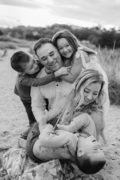 a woman playing with three small kids