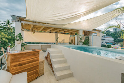 The pool at Alchemize House in Sayulita offers a tranquil space for relaxation, social connection, and post-class rejuvenation as part of the community wellness experience.