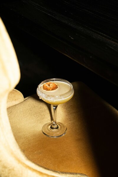 Classy and luxe passion fruit martini glass and brands and strategy by Her Higher Standard Design Studio