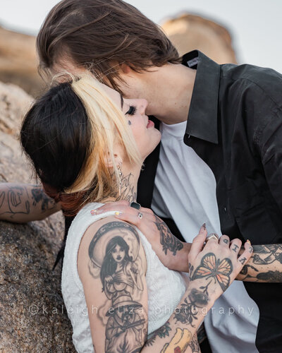 couple kissing during sunrise engagement session