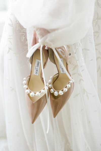 bride holding Jimmy Choo shoes before Cleveland Ohio Wedding