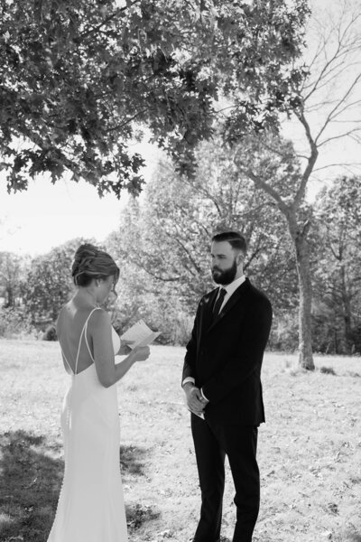 Bride reading her vows to the groom.