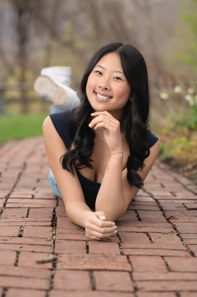 Senior photos of a girl at Fort Hunter Mansion and Park. Brick sidewalk. 