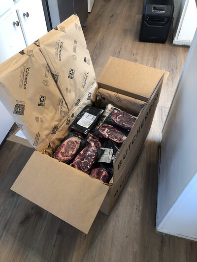 Box of frozen steaks.