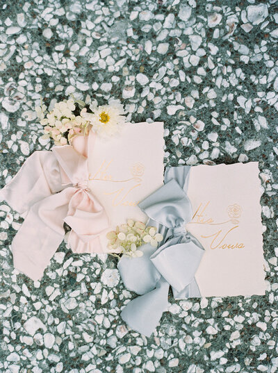 Wedding vow cards with ribbons on a stone background