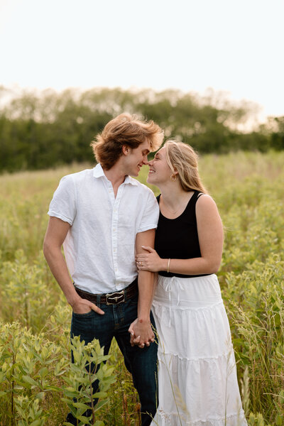 couple laughs during engagement photoshoot in kansas city missouri