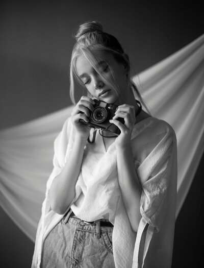 Woman who is enjoying the camera that she is holding