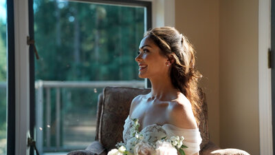bride smiling while holding bridal bouquet