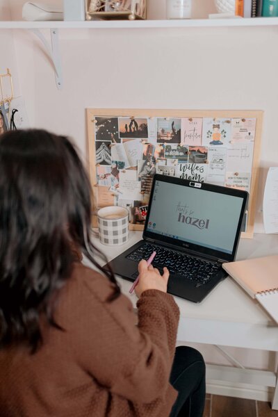 woman working on laptop on desk