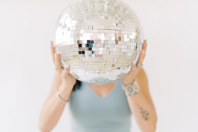 Woman holding a disco ball