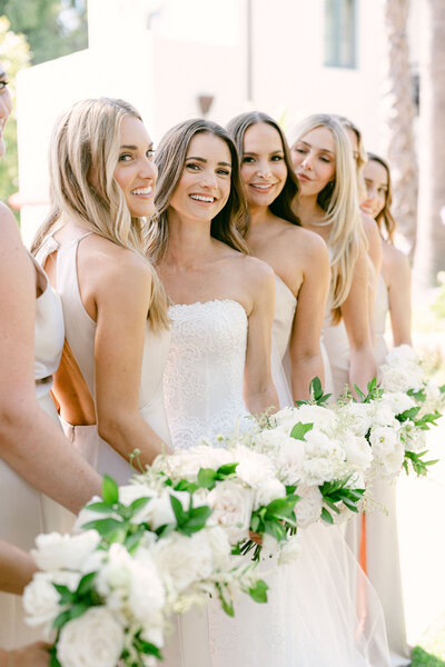 bride stands on the balcony at Vibiana and her portrait is taken through the doors overlooking the city of los angeles captured by los angeles wedding photographer magnolia west photography