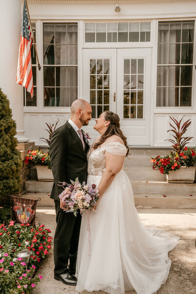 Bride and groom sharing a joyful moment together on their wedding day in Columbus, Ohio, captured in a beautiful outdoor setting.