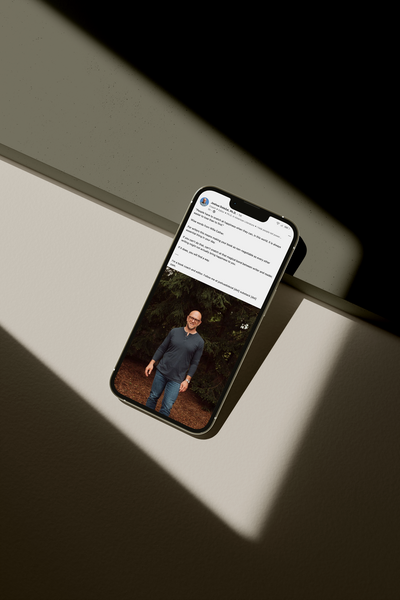 Mockup of a phone displaying a writing coach's LinkedIn post.