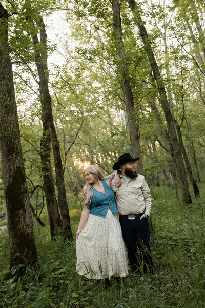 Couple captured in a romantic moment outdoors, surrounded by nature’s beauty, showcasing their love against a serene landscape.