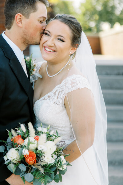 megan and her fiance josh in their engagement photo outside