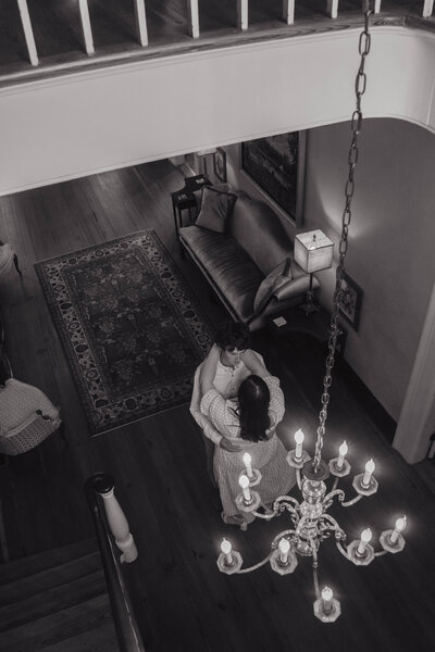 Black-and-white overhead shot of bride and groom dancing in a quiet, candlelit room — intimate Alabama wedding photography by EC Photography