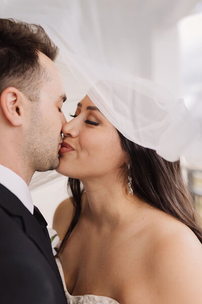 bride and groom first kiss after sarasota wedding ceremony