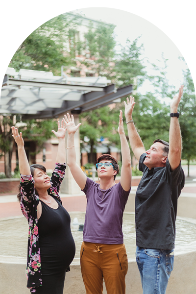 three people with hands in the air psychic reading