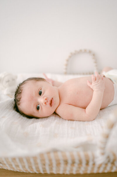 Newborn baby girl in changing basket by Miami Newborn Photography